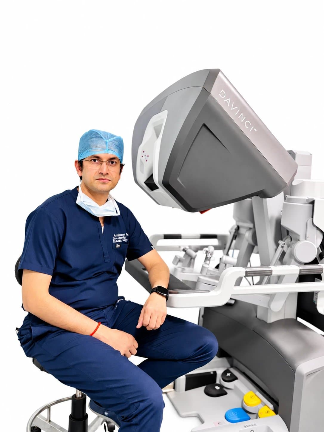 Dr. Anshuman Singh seated beside the surgeon console of a robotic surgical system